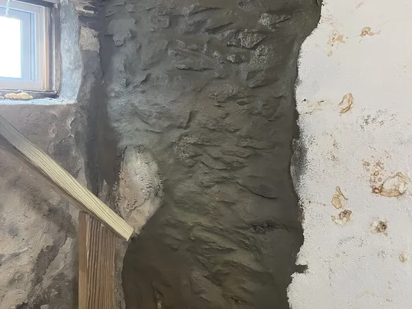The same interior stone foundation after fresh mortar repointing